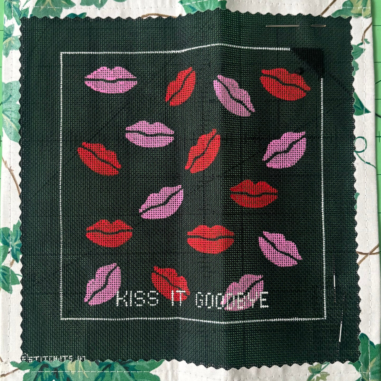 A Needlepoint canvas with lips in both pink and red with the text "Kiss It Goodbye " underneath