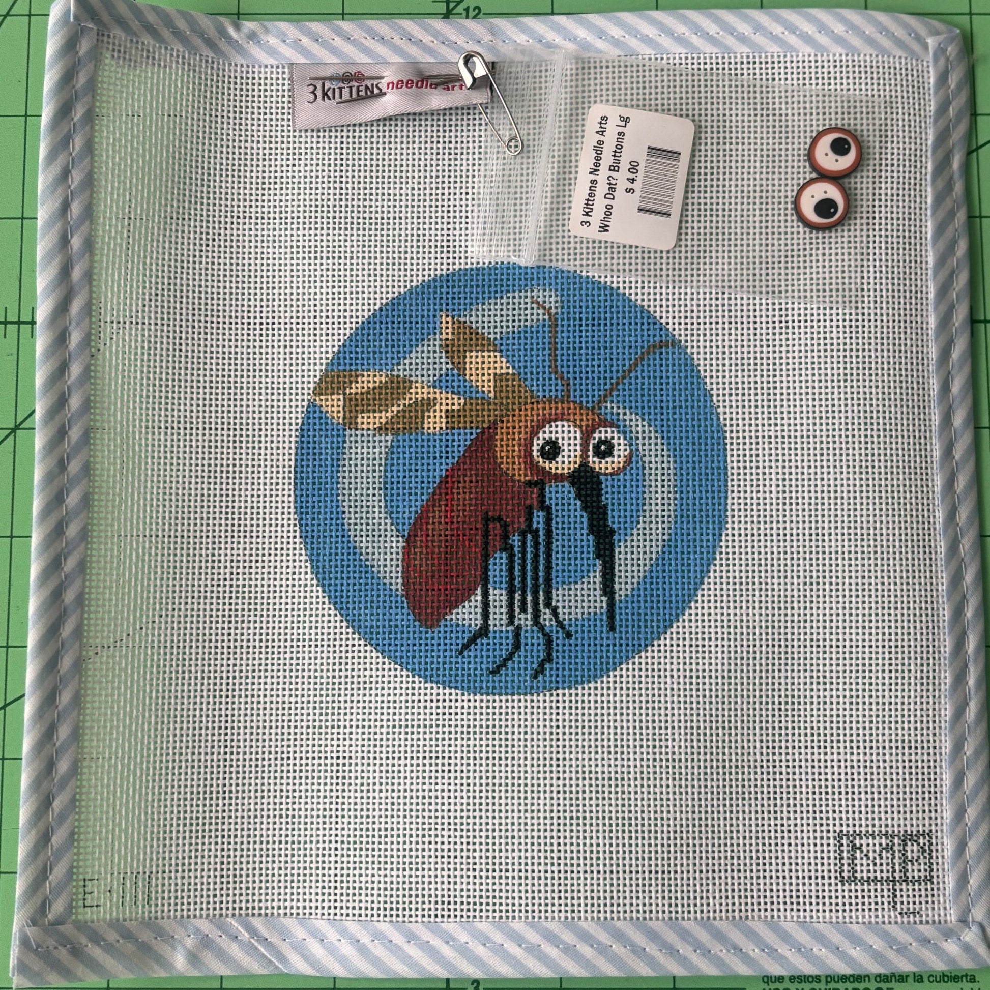 A needlepoint canvas with a mosquito flying on top of a blue sky