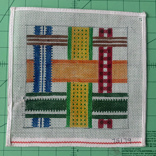 A needlepoint canvas with a woven/plaid design